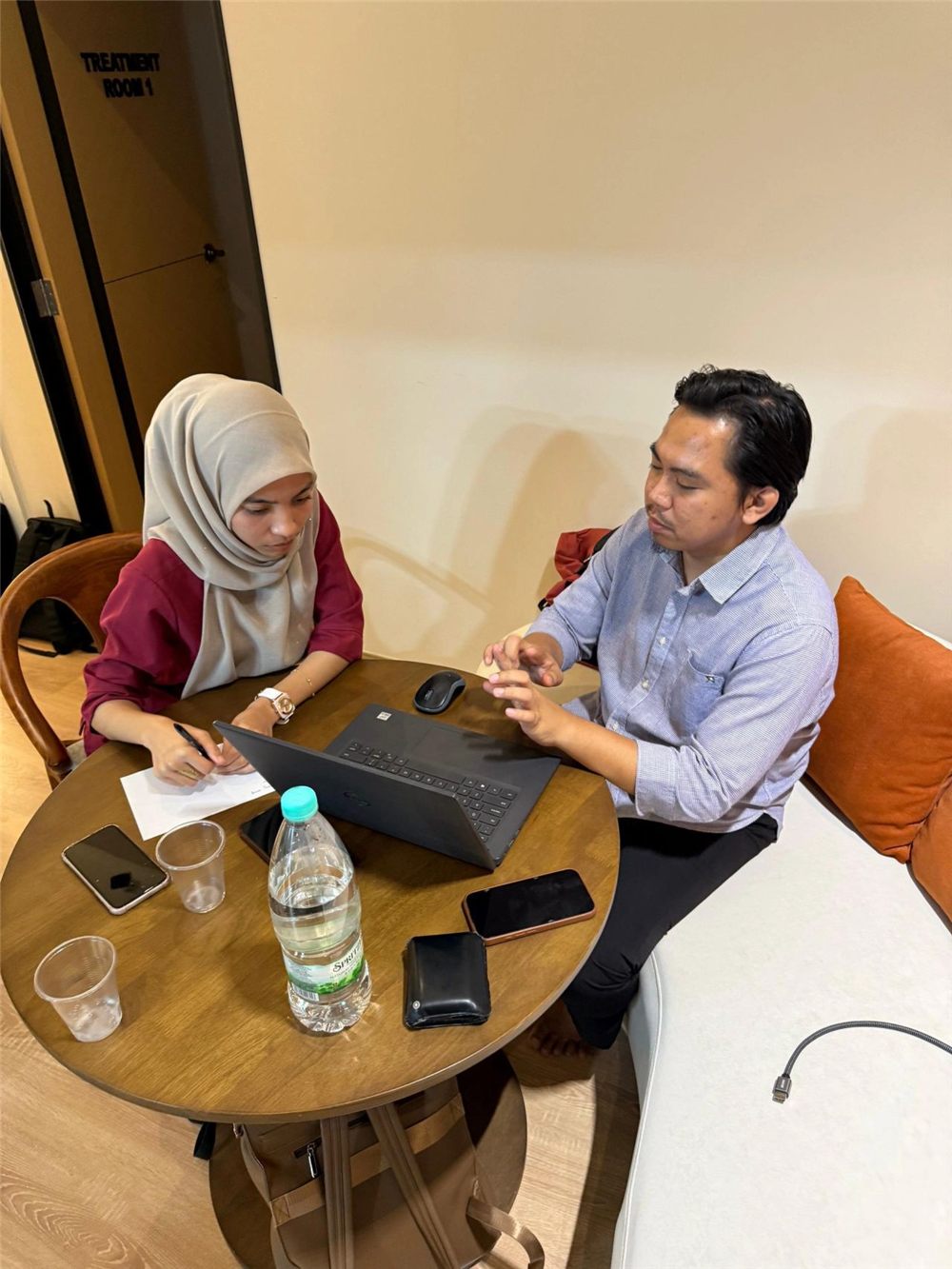 A partnership conversation, one on one across a small table.