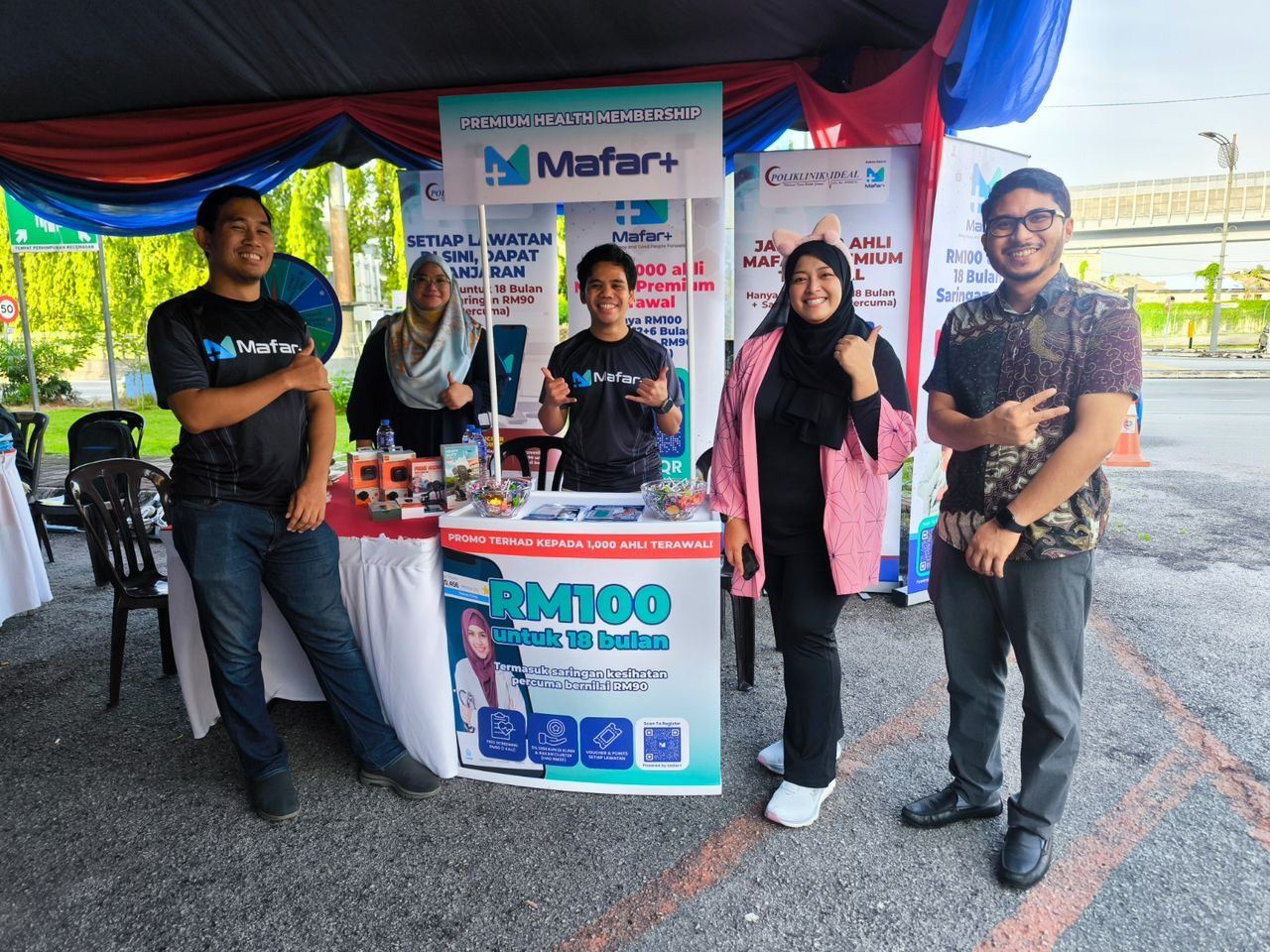 The Mafar+ booth at a community event, the team in Mafar+ shirts.