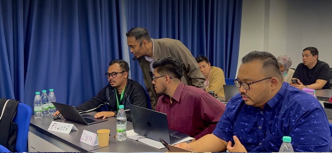Doctors working through their own clinic numbers on laptops.
