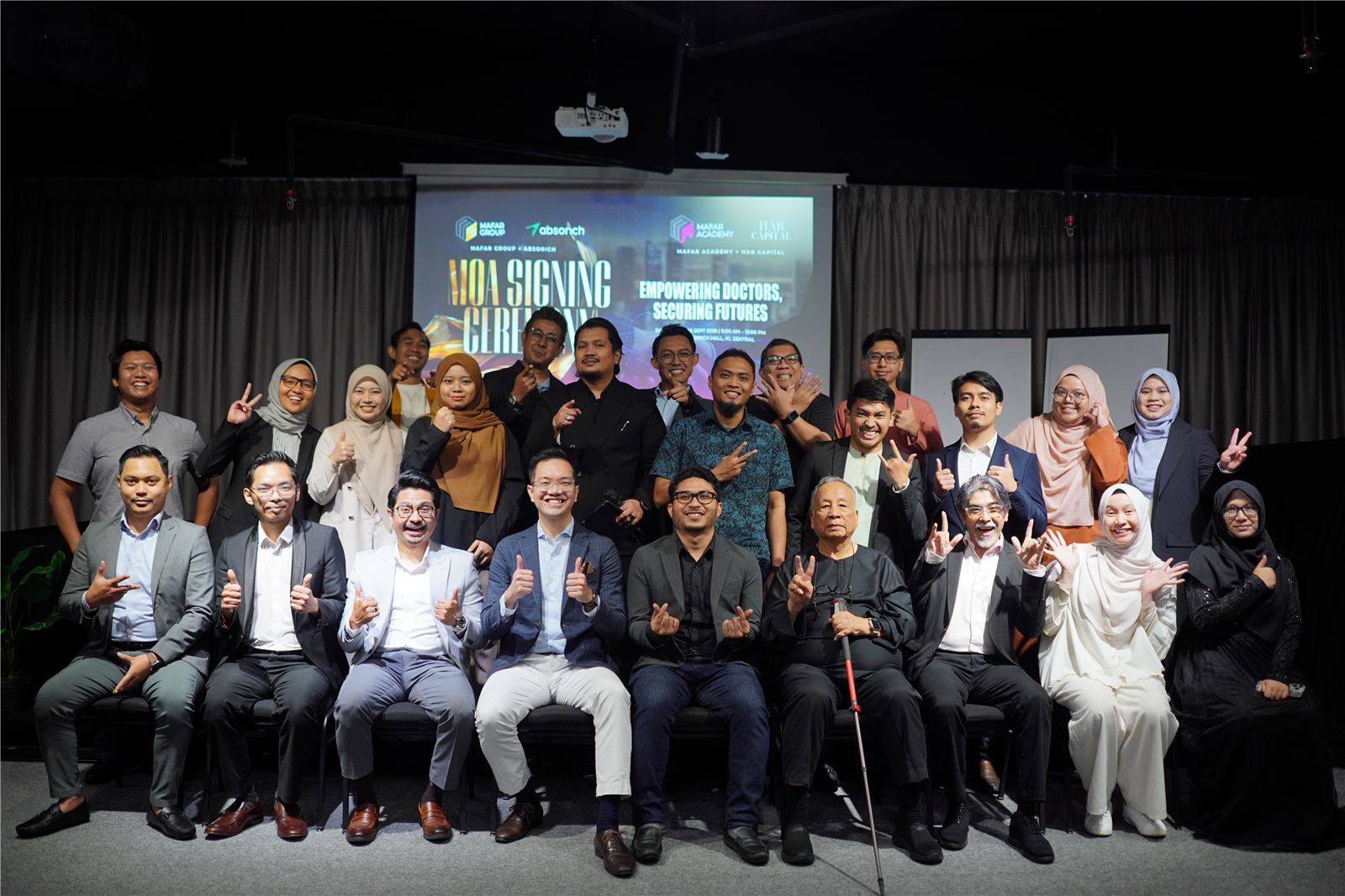 The MOA signing ceremony, partners and leadership on stage.
